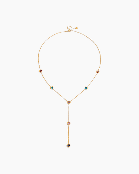 Gold necklace with colorful gemstones on a white background