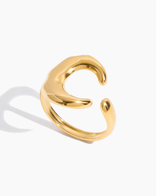 Gold open ear cuff on a white background