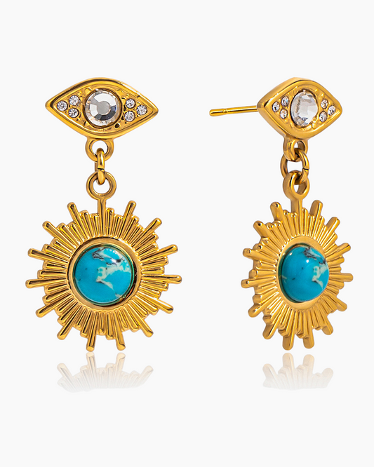 Gold earrings with turquoise stones on a white background