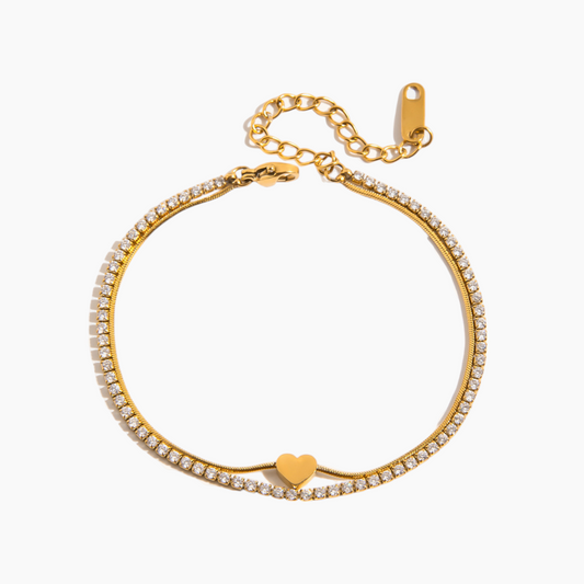 Gold bracelet with heart charm on a white background