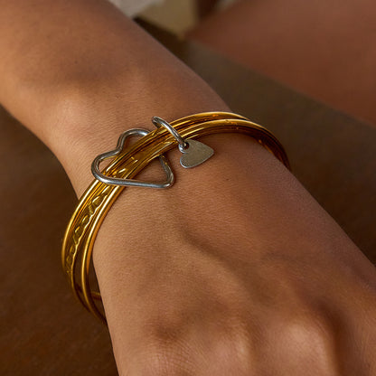 Gold charm bangle styled with denim for a casual summer look