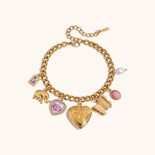 Gold heart charm bracelet with butterfly, pink crystal, and floral heart