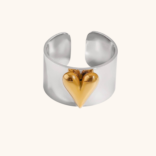 Close-up of two-tone heart ring in glossy gold and silver finish