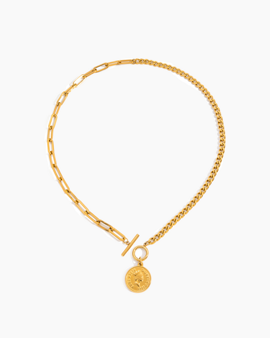 Gold chain necklace with a round pendant on a white background