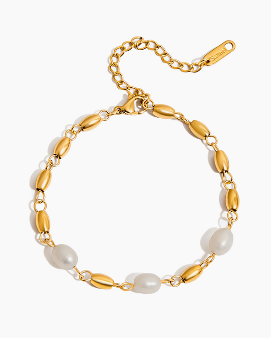 Gold bracelet with pearls on a white background