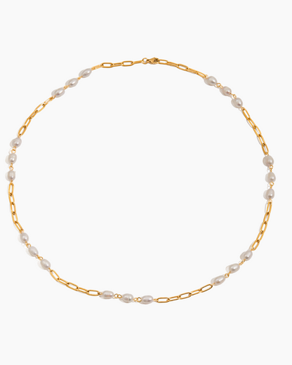 Gold chain necklace with pearls on a white background
