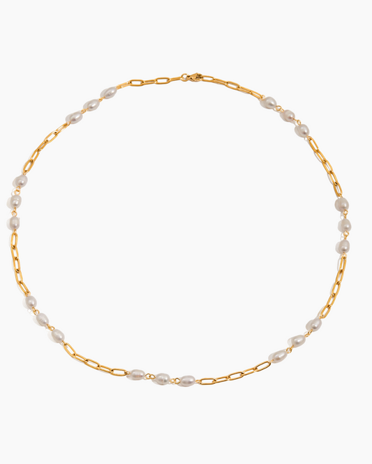 Gold chain necklace with pearls on a white background