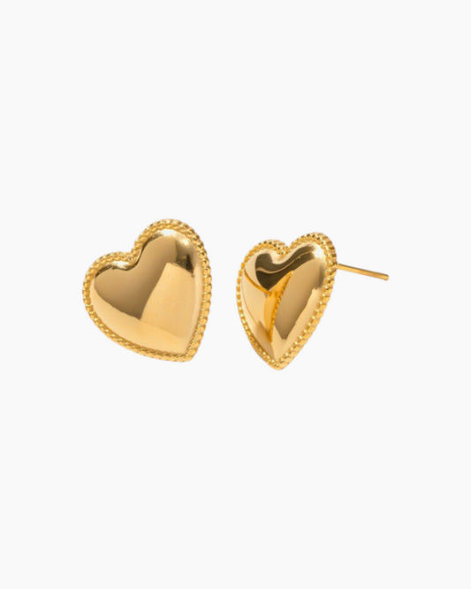 Gold heart-shaped earrings on a white background