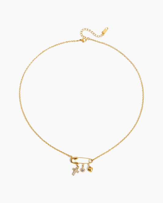Gold necklace with three small pendants on a white background