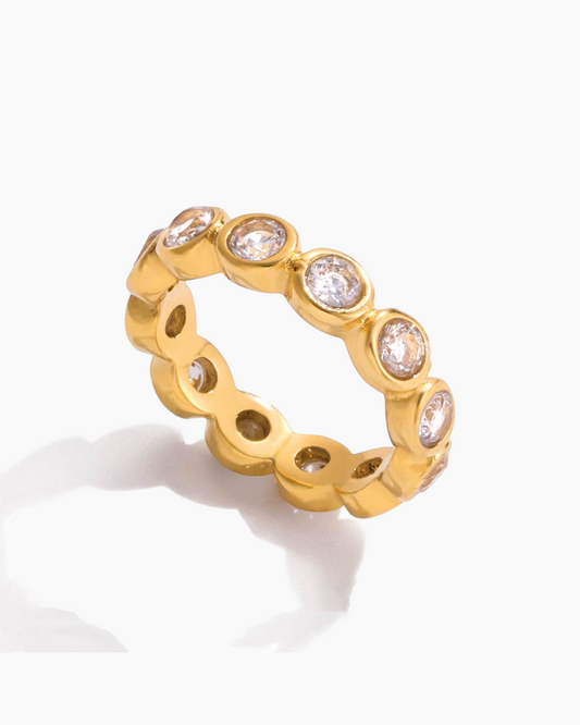 Gold ring with embedded diamonds on a white background