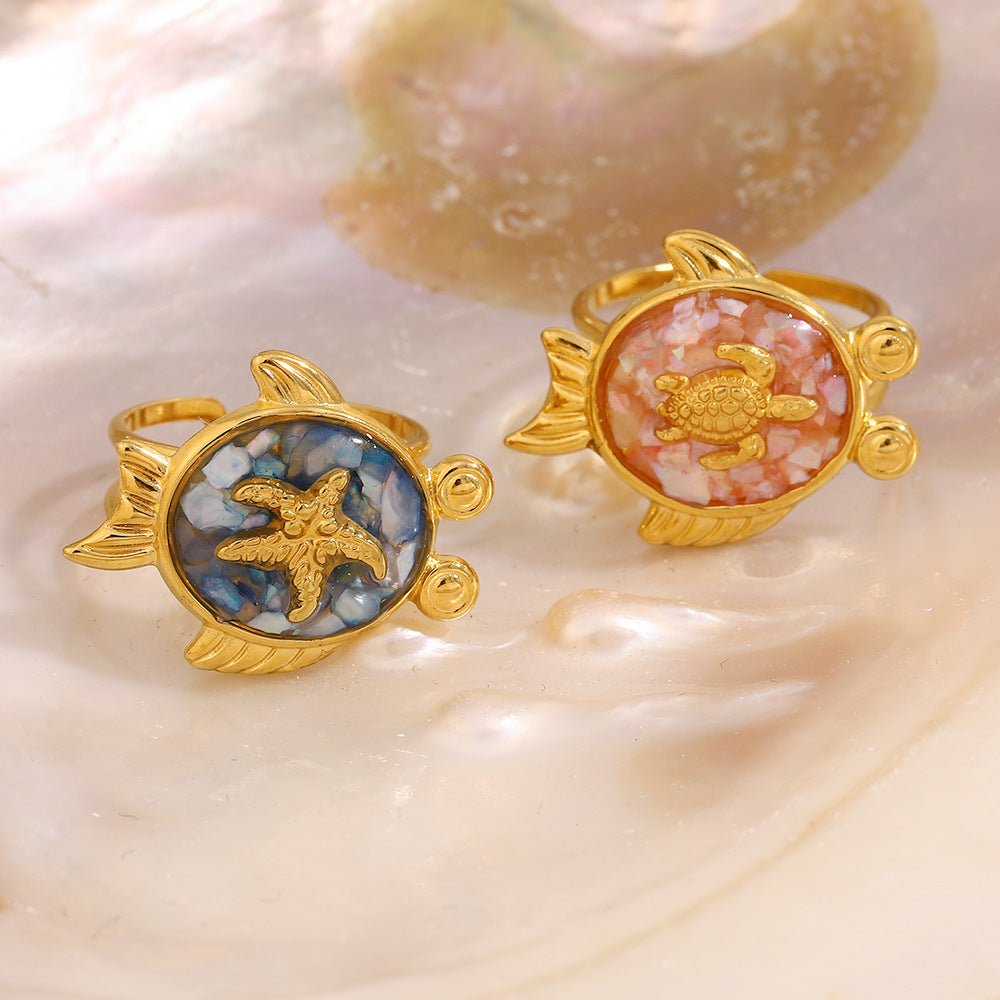 Turtle design rings placed on iridescent mother of pearl shell