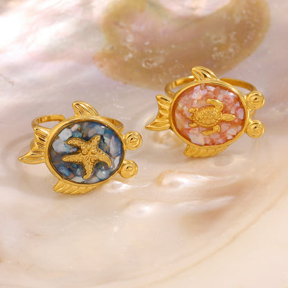 Turtle design rings placed on iridescent mother of pearl shell