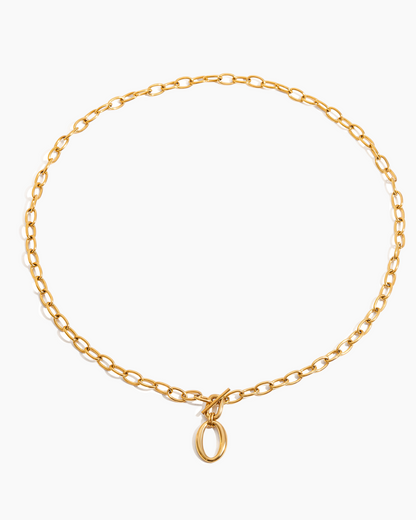 Gold chain necklace with a small pendant on a white background