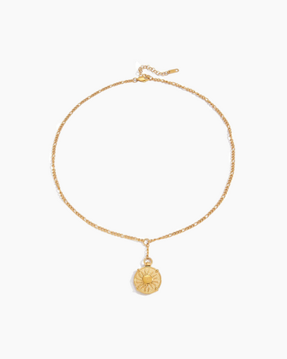 Gold necklace with a round pendant on a white background