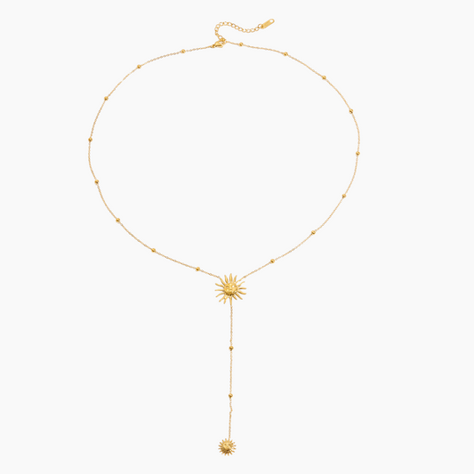 Gold necklace with a sunflower pendant on a white background