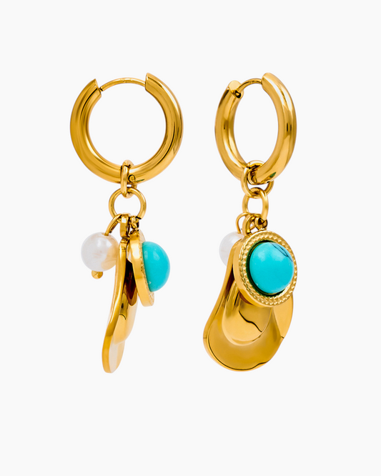 Gold hoop earrings with turquoise and pearl charms on a white background