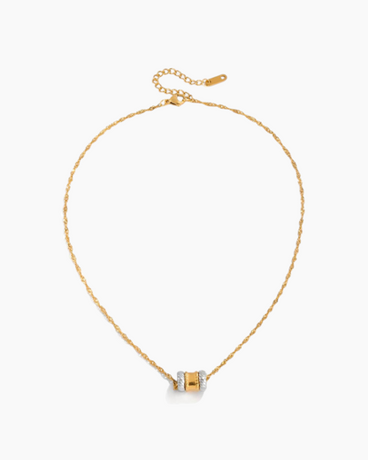 Gold necklace with a small pendant on a white background