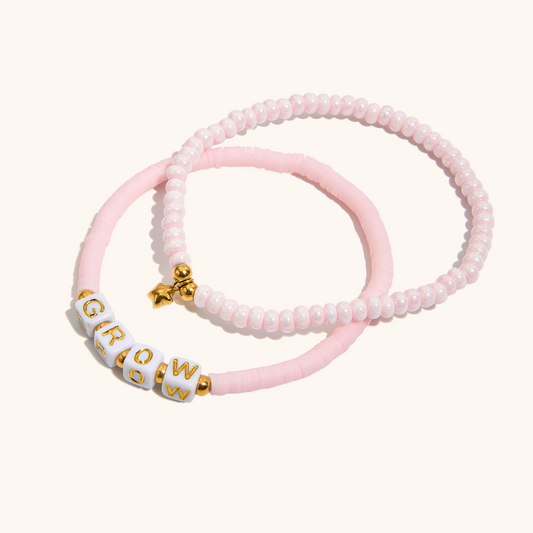 Set of pastel beaded bracelets with gold heart and star accents