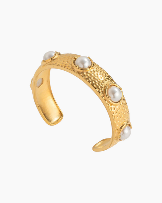 Gold ring with pearlstones on a white background