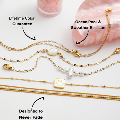 Gold necklaces with various pendants on a white background, featuring text about color guarantee and resistance to ocean, pool, and weather.
