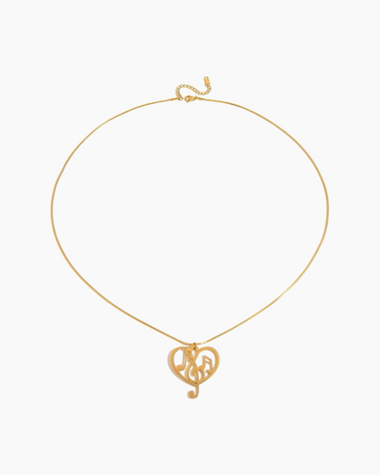 Gold necklace with a heart-shaped pendant on a white background