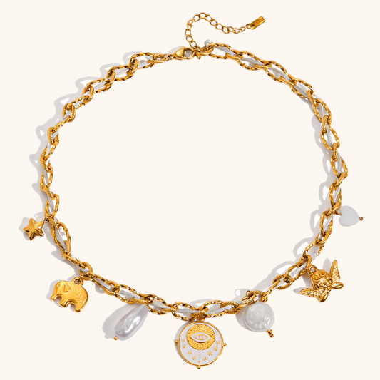 Close-up of gold chain necklace with star, elephant, pearl, and angel charms