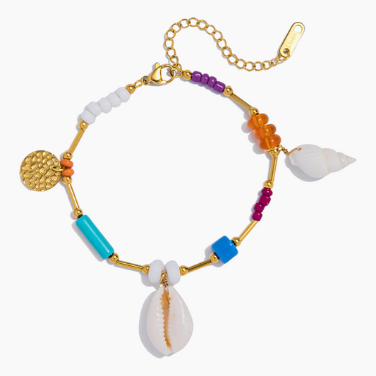 Colorful bracelet with beads and shell on a white background