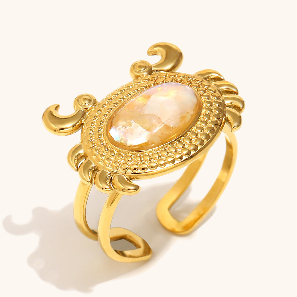 Gold crab-shaped ring with soft ivory-toned shell, perfect for coastal vibes.