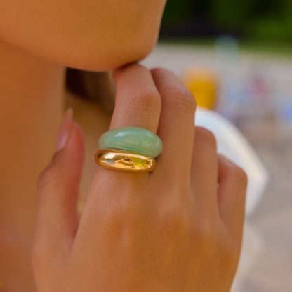 Glossy jade-look ring with gold accent worn by female model