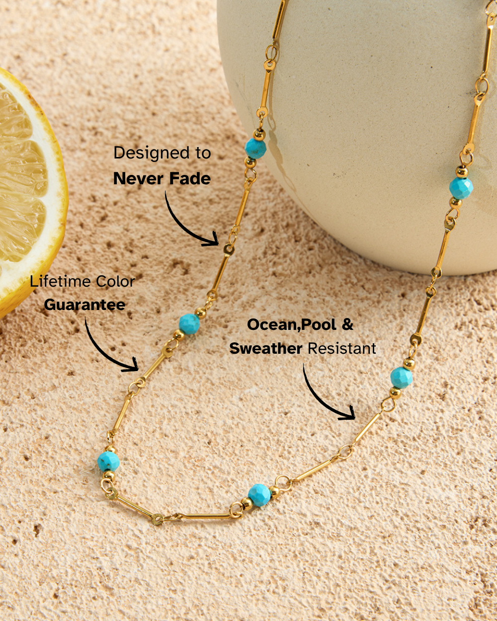 Gold necklace with blue beads on a sandy background, highlighting features like 'Designed to Never Fade' and 'Lifetime Color Guarantee'.