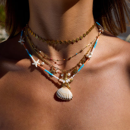 Layered summer necklaces with gold and beaded strands styled on female model