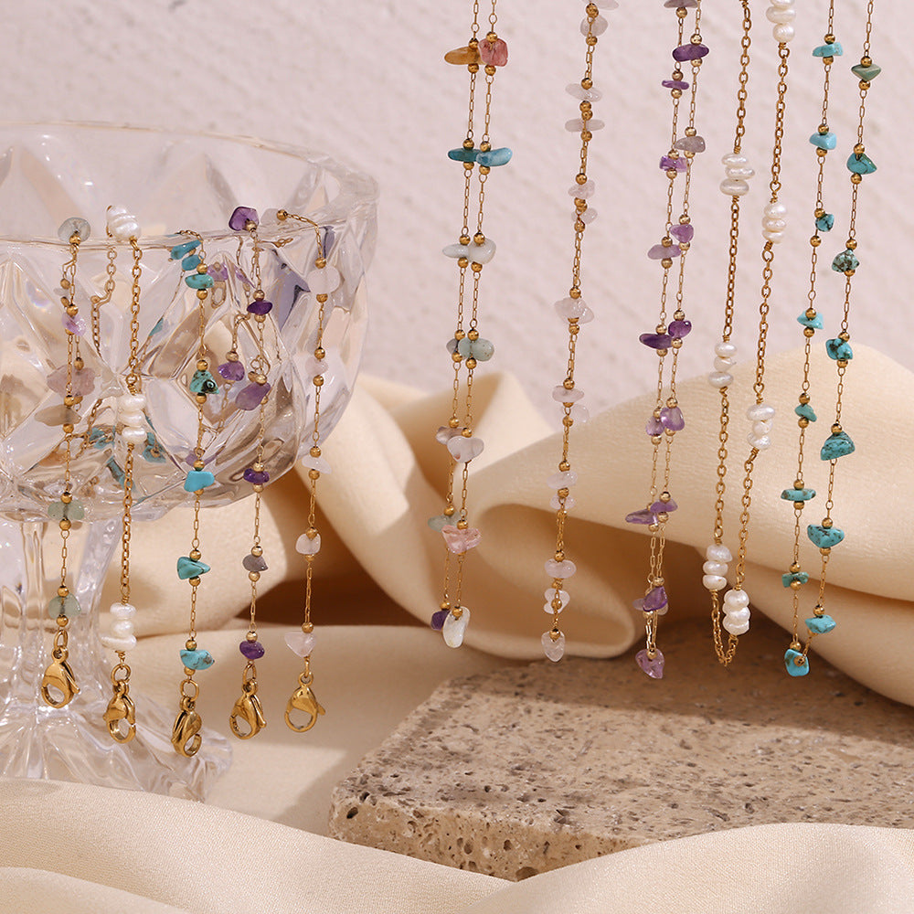 Hanging gemstone necklaces including pearls, turquoise, and amethyst