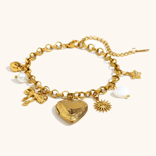 Gold-tone multi-charm bracelet with engraved heart, star and pearl elements