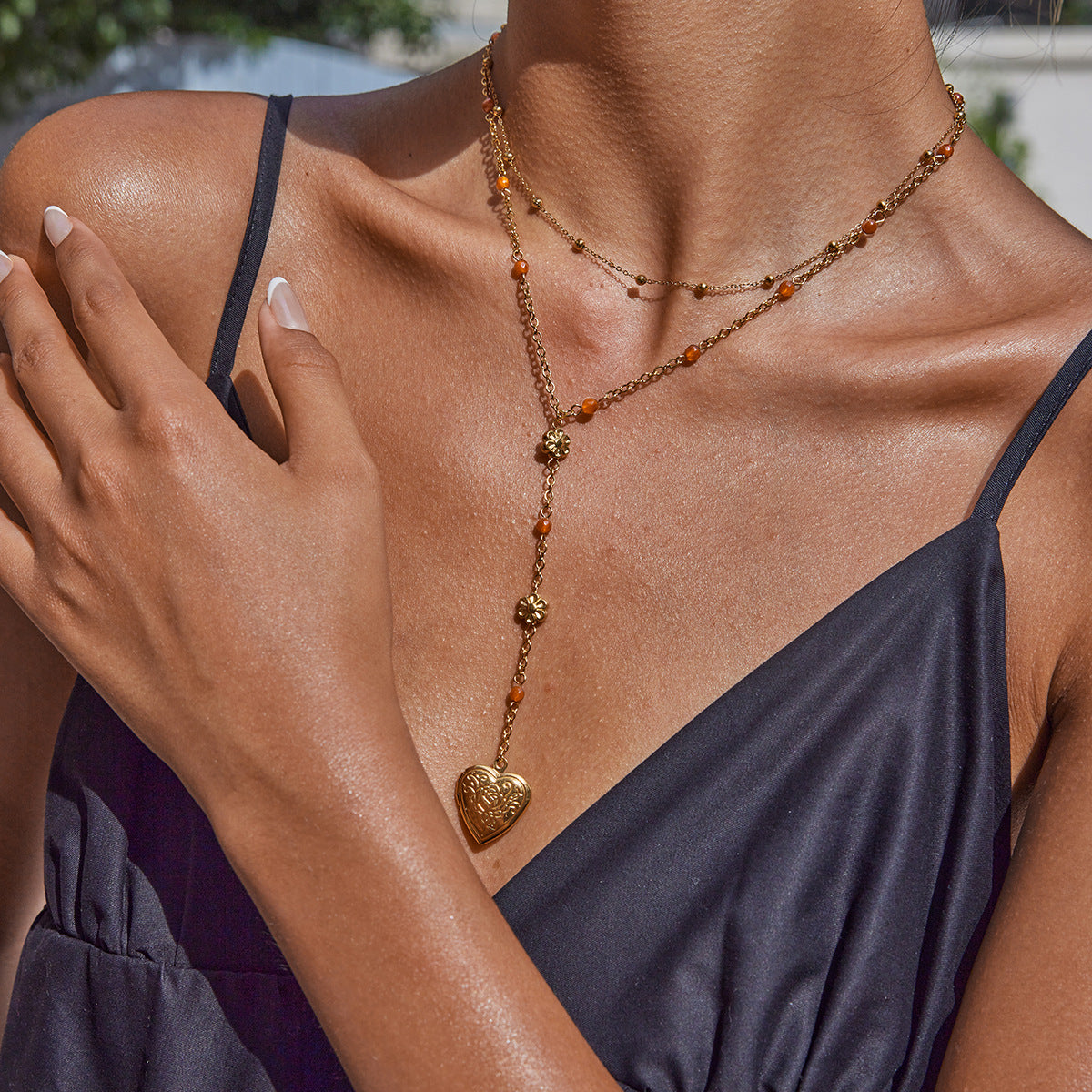 Model wearing summer-ready waterproof heart necklace