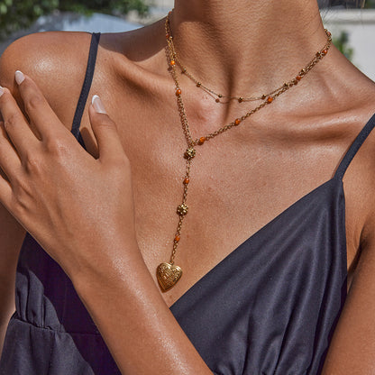 Model wearing summer-ready waterproof heart necklace