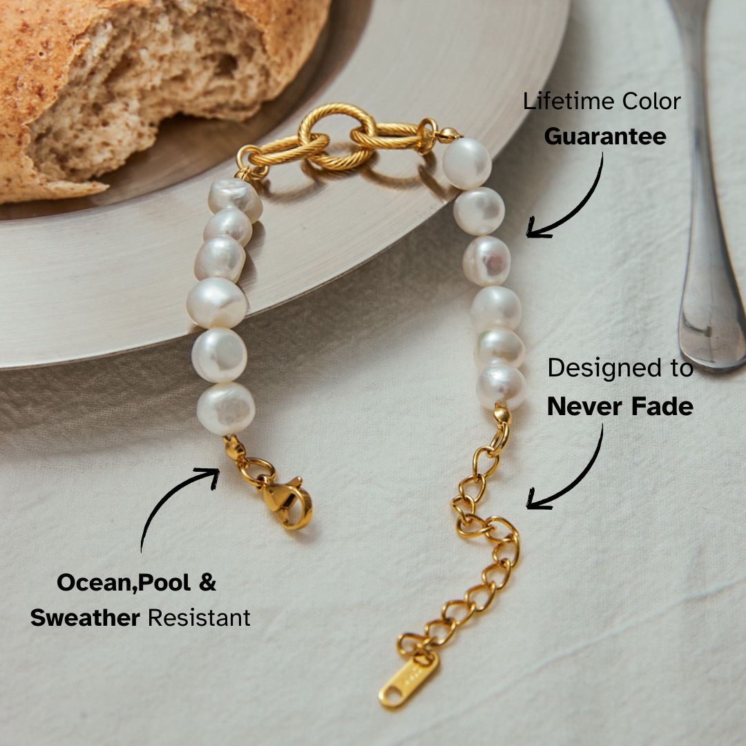 Stacked gold and pearl bracelet worn with chunky gold bangles