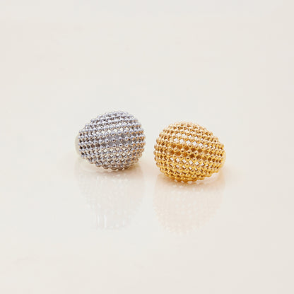 Silver statement ring styled on finger with natural nails