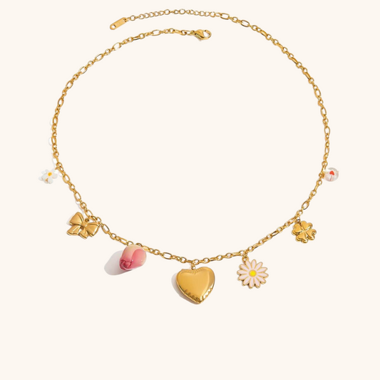 Pink dried rose charm necklace with daisy and four-leaf clover, modeled with layered chains