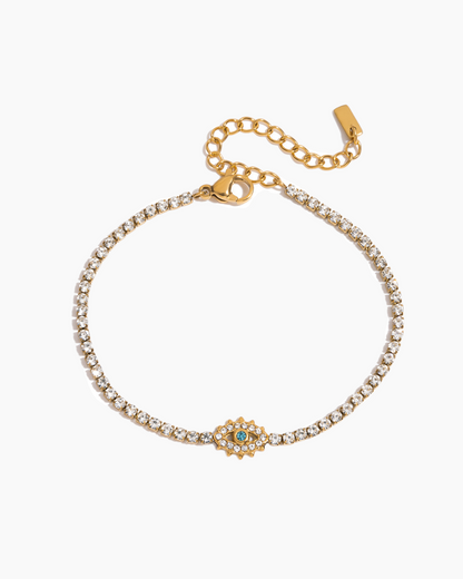 Gold bracelet with a decorative clasp on a white background