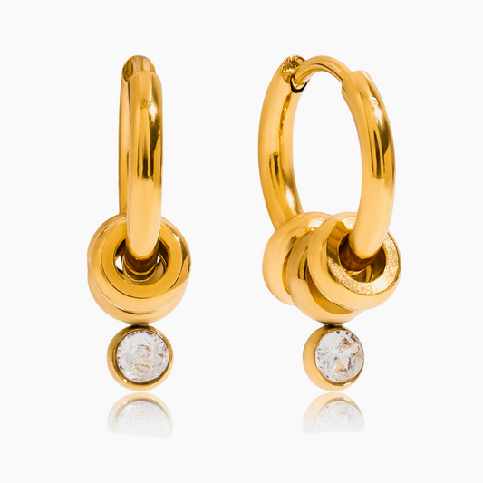 Gold hoop earrings with small round stones on a white background