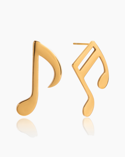 Gold music note earrings on a white background