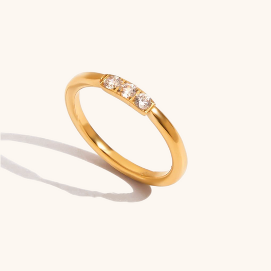 Slim gold band ring with three tiny cubic zirconia