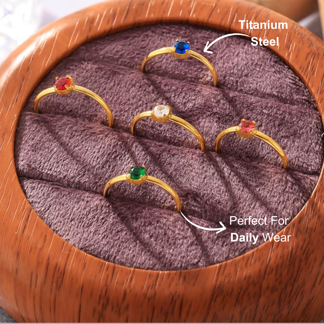 Minimalist adjustable zircon open ring displayed in a jewelry box with colorful stones.