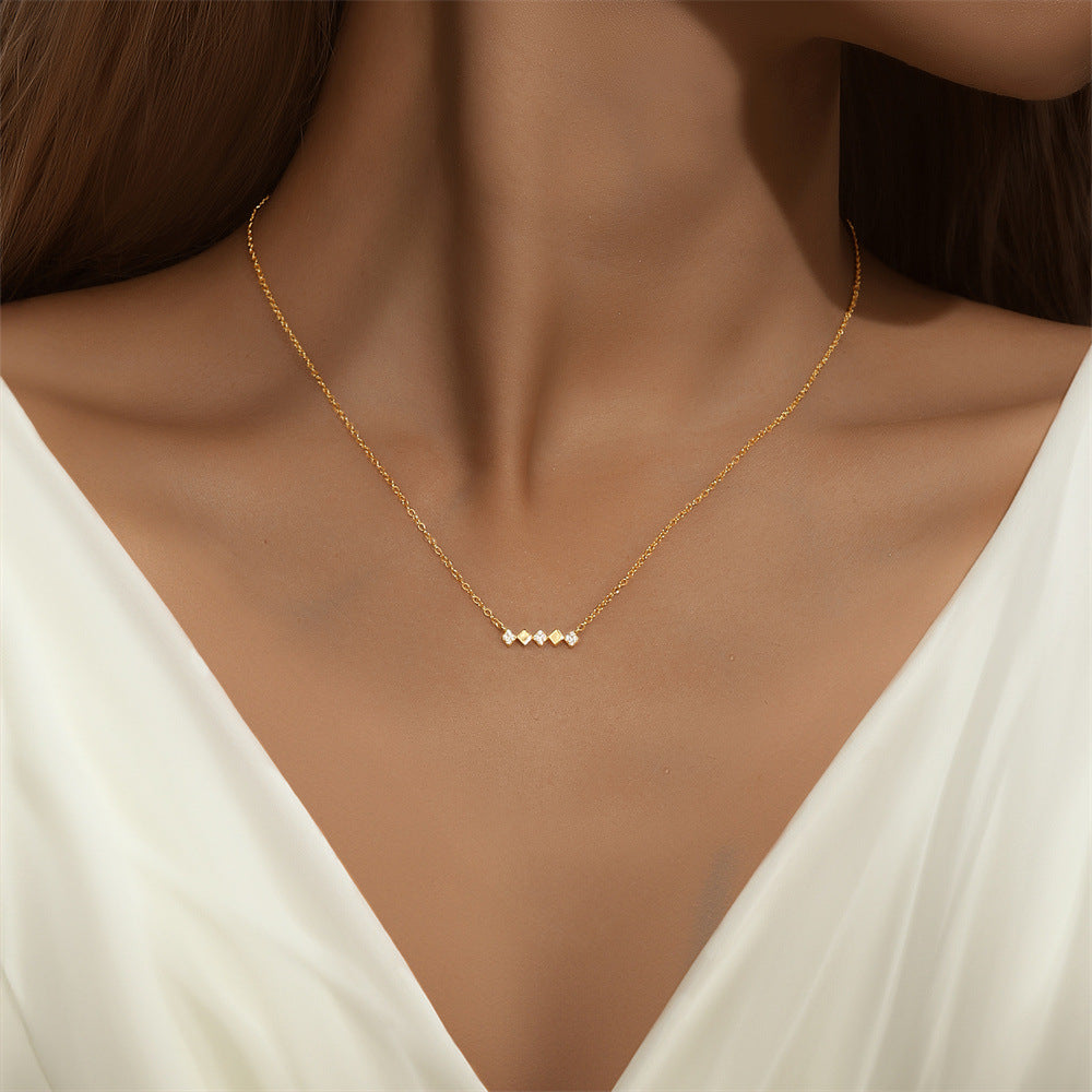Minimalist gold-plated geometric bar necklace with cubic zirconia, perfect for layering.