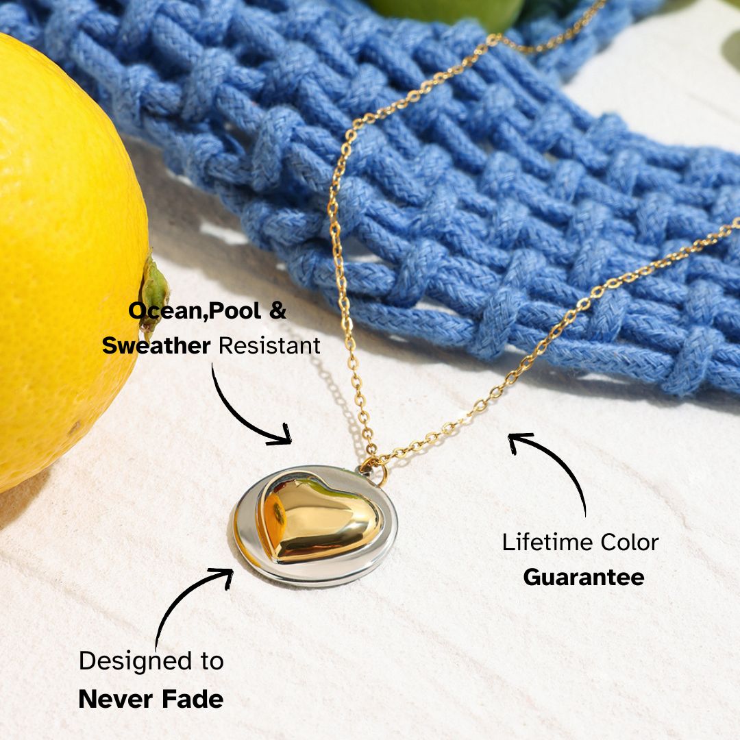 Studio shot of minimalist two-tone heart necklace with gold heart charm, ideal for daily layering
