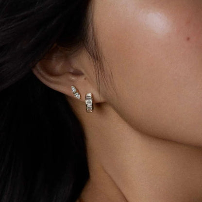 Everyday gold huggies styled with layered ear piercings