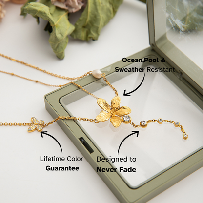 Gold necklace with butterfly design on a display card, featuring text about water resistance and color guarantee.