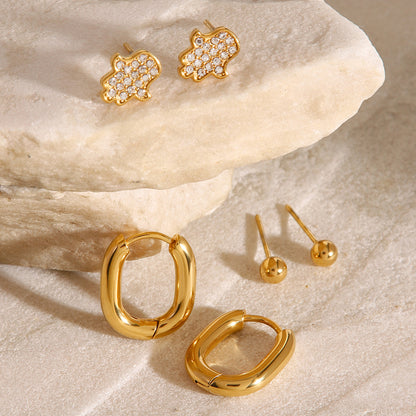 Waterproof gold earring set with hoops, studs, and crystal charms, ideal for multiple piercings.