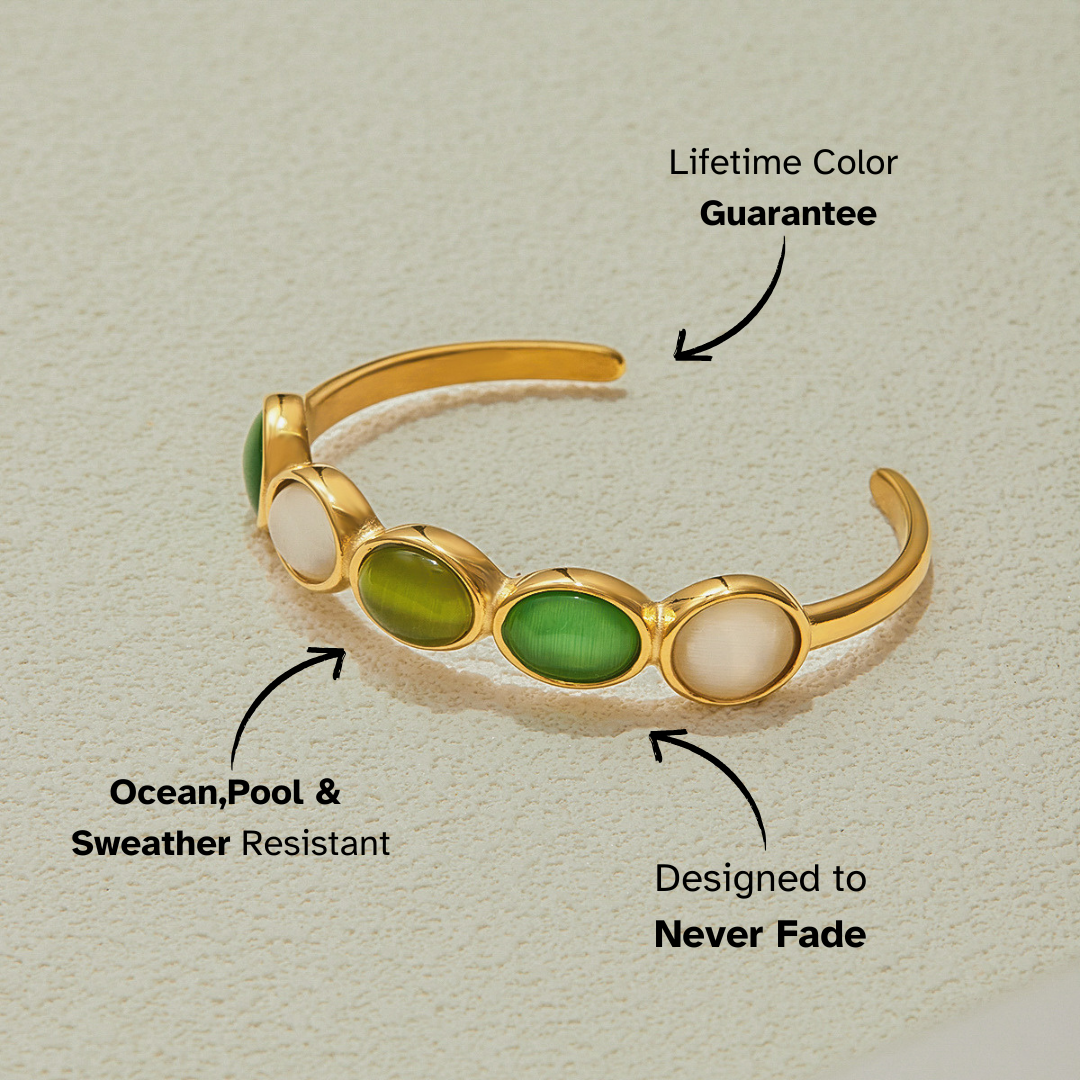 product close-up of gemstone cuff with glossy green and pearl-tone inlays