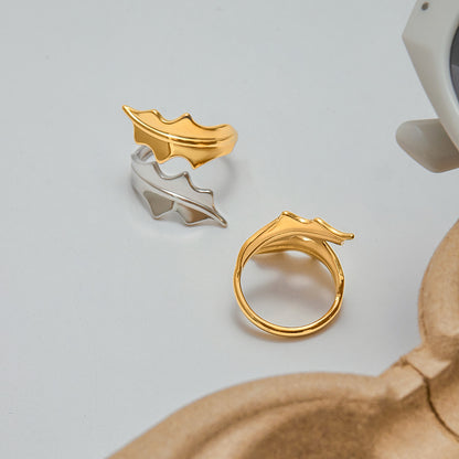 Mixed metal leaf rings styled on fingers, perfect for summer outfits